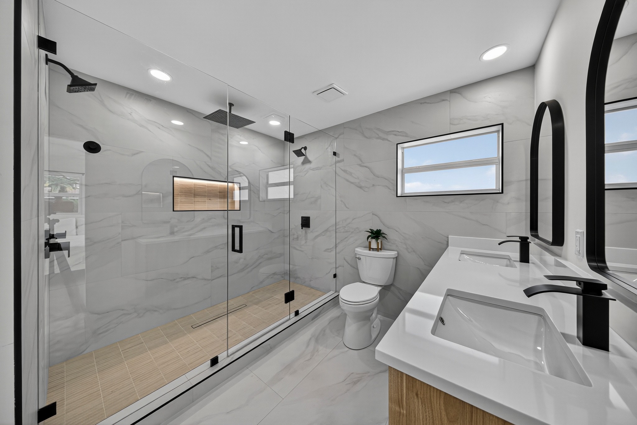 Modern bathroom remodel with walk-in shower and double vanity in Palm Beach County